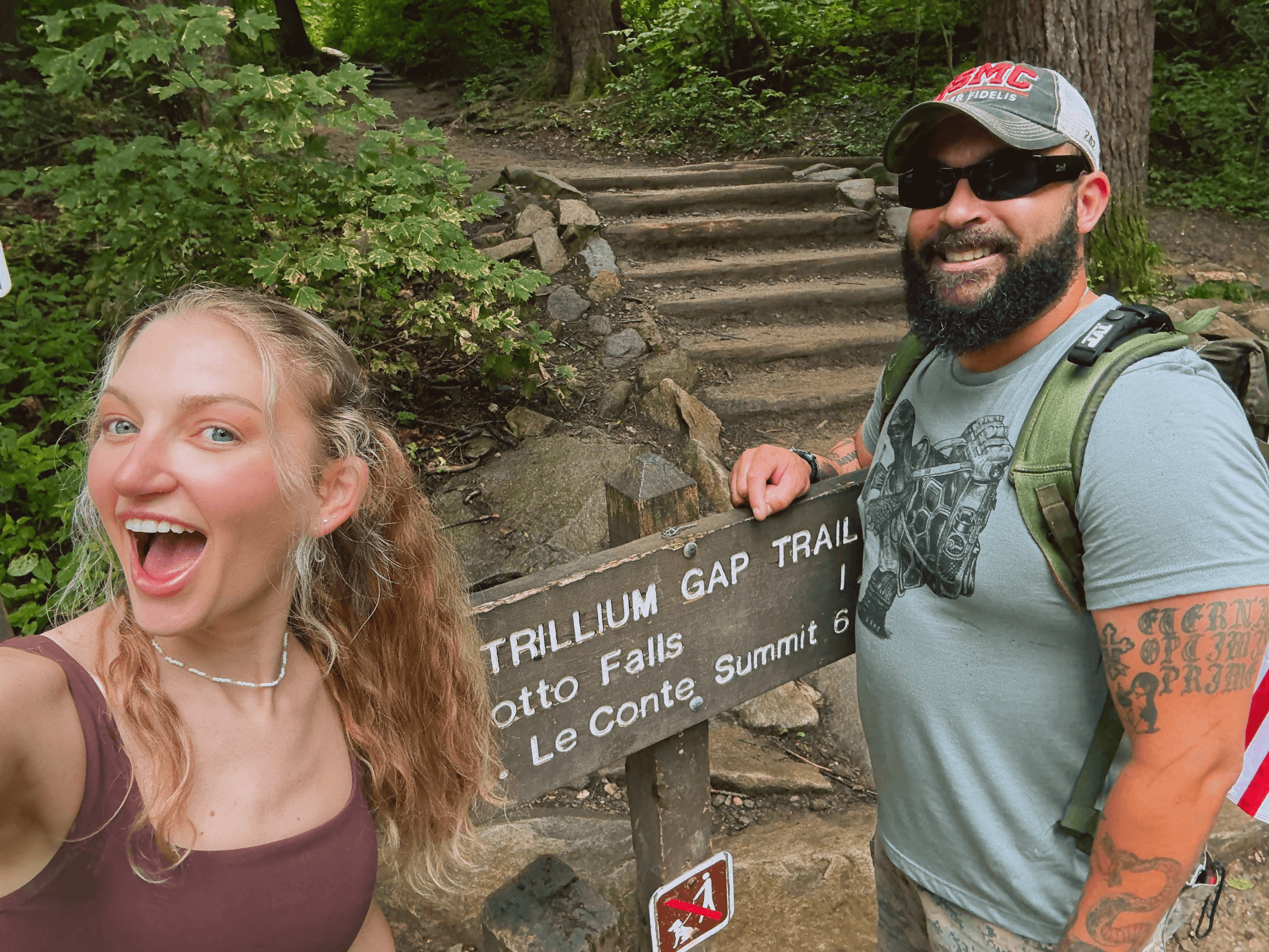 Nick & Allison posing for a photo in nature
